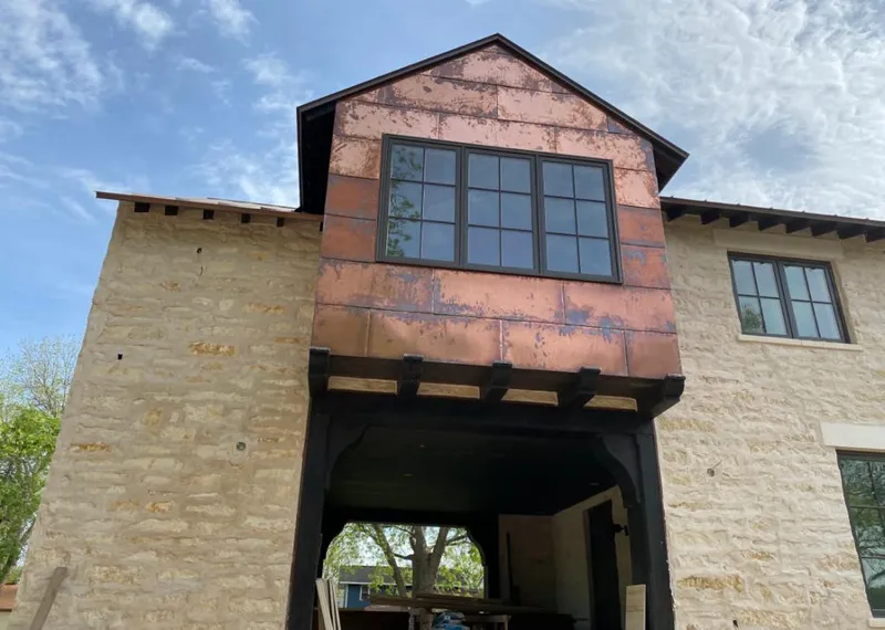 Copper metal panel facade on a stone building for Roof Repair in Gulf Shores