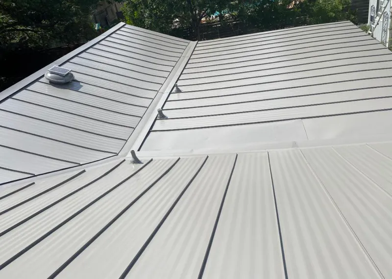 Solar attic fan installed on a metal roof for Roof Ventilation in Gulf Shores